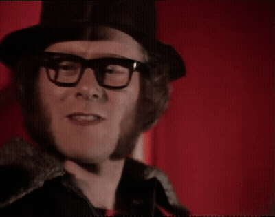 A Man Wearing Glasses And A Top Hat Says Is It GIF