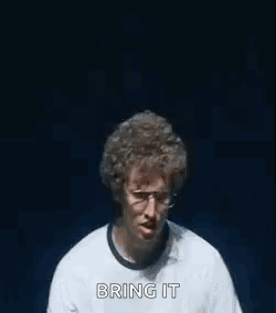 A Man Wearing Glasses And A Watch Is Making A Funny Face With His Hands . GIF