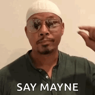 A Man Wearing Glasses And A White Hat Is Holding A Pill In His Hand . GIF
