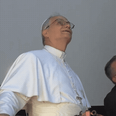 A Man Wearing Glasses And A White Robe Looks Up At The Sky GIF