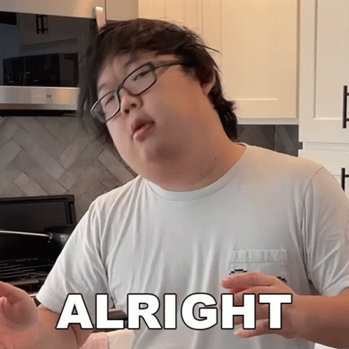 A Man Wearing Glasses And A White Shirt Has The Word Alright On His Chest GIF