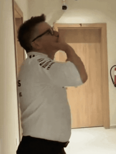 A Man Wearing Glasses And A White Shirt With The Number 5 On It GIF