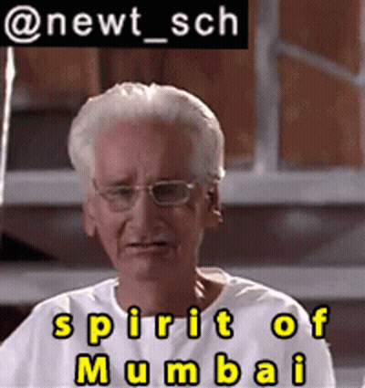 A Man Wearing Glasses And A White Shirt With The Words Spirit Of Mumbai Below Him GIF