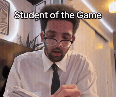 A Man Wearing Glasses And A White Shirt With The Words Student Of The Game Written On It GIF