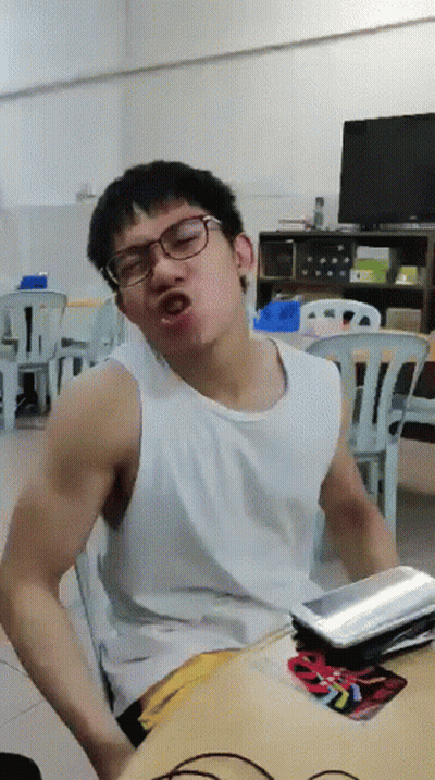 A Man Wearing Glasses And A White Tank Top Is Making A Funny Face GIF