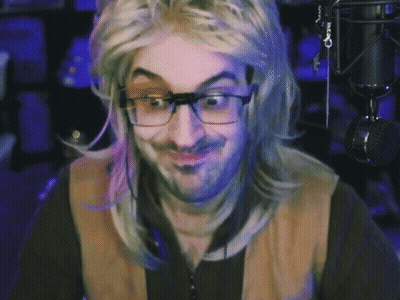A Man Wearing Glasses And A Wig Is Giving A Thumbs Up Sign GIF