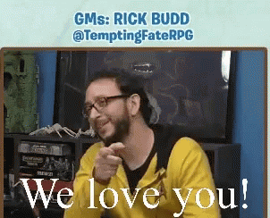 A Man Wearing Glasses And A Yellow Hoodie Says We Love You GIF