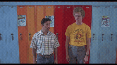 A Man Wearing Glasses And A Yellow Shirt That Says ' Ricks College ' GIF