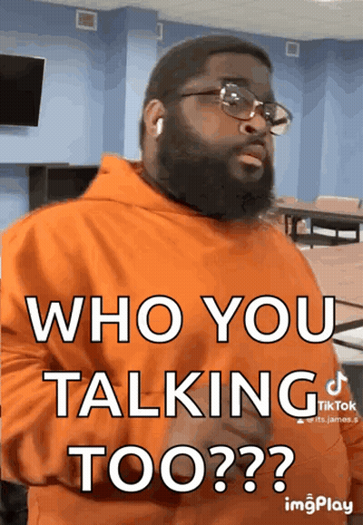 A Man Wearing Glasses And An Orange Hoodie Says Who You Talking Too ? GIF