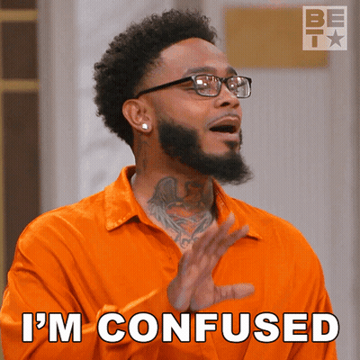 A Man Wearing Glasses And An Orange Shirt Says " I 'M Confused " GIF