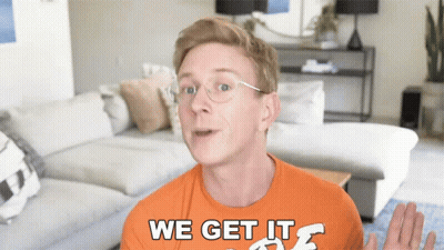 A Man Wearing Glasses And An Orange Shirt That Says We Get It GIF