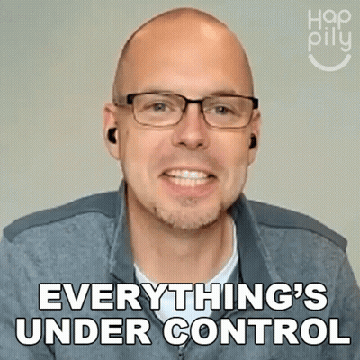 A Man Wearing Glasses And Ear Buds Is Smiling And Says Everything 'S Under Control GIF