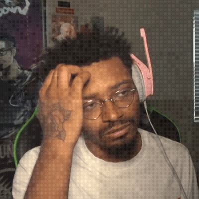 A Man Wearing Glasses And Headphones Has A Tattoo On His Arm GIF