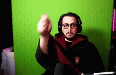 A Man Wearing Glasses And Headphones Is Giving The Middle Finger In Front Of A Green Background GIF