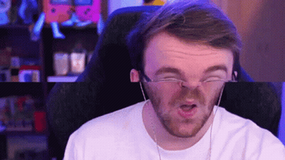 A Man Wearing Glasses And Headphones Is Making A Funny Face . GIF