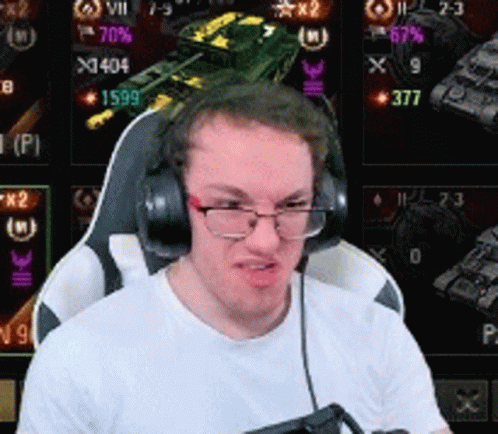 A Man Wearing Glasses And Headphones Is Playing A Video Game . GIF