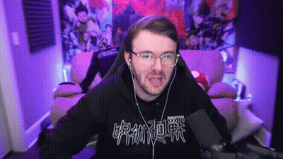 A Man Wearing Glasses And Headphones Is Sitting In Front Of A Microphone With Chinese Writing On His Shirt GIF