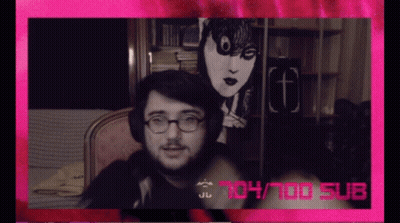 A Man Wearing Glasses And Headphones Is Sitting In Front Of A Pink Background That Says 104/100 Sub GIF