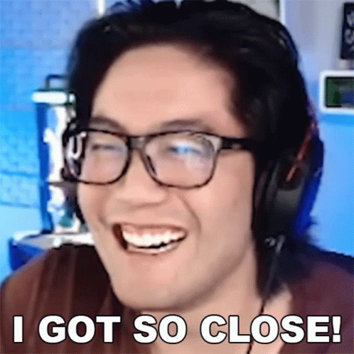 A Man Wearing Glasses And Headphones Is Smiling With The Words I Got So Close Behind Him GIF