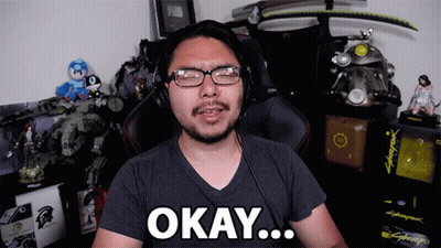 A Man Wearing Glasses And Headphones Says Okay In Front Of A Cyberpunk Game GIF