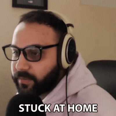 A Man Wearing Glasses And Headphones Says " Stuck At Home " GIF