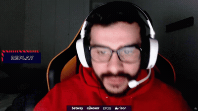 a man wearing glasses and headphones with a replay sign in the corner