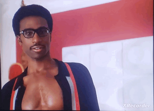 A Man Wearing Glasses And Suspenders Is On A Tv Screen With Xrecorder Written On The Bottom GIF