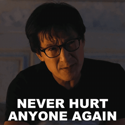 A Man Wearing Glasses Has The Words Never Hurt Anyone Again Above His Head GIF