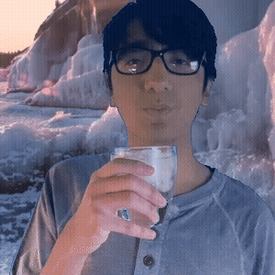 A Man Wearing Glasses Holds A Glass Of Water GIF