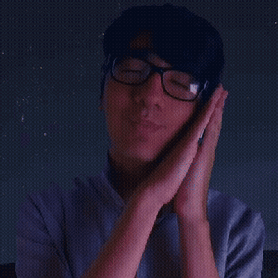 A Man Wearing Glasses Holds His Hands To His Face In Prayer GIF
