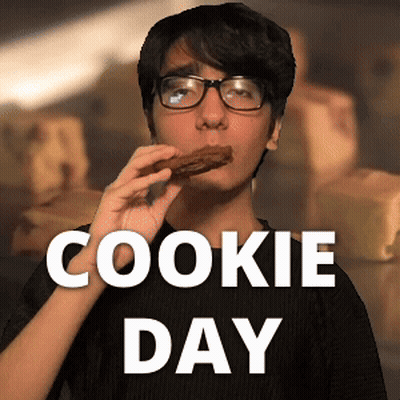 A Man Wearing Glasses Is Eating A Cookie With The Words Cookie Day Behind Him GIF