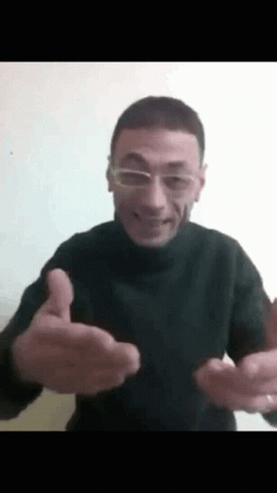 A Man Wearing Glasses Is Giving A Thumbs Up Sign . GIF