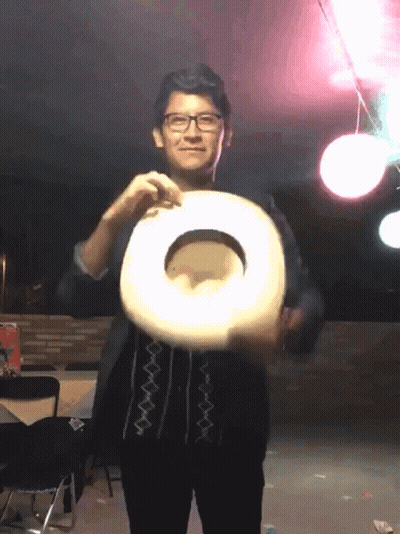 A Man Wearing Glasses Is Holding A Cowboy Hat In His Hand GIF