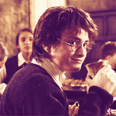 A Man Wearing Glasses Is Holding A Cup In His Right Hand GIF
