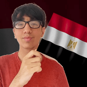 A Man Wearing Glasses Is Holding A Egyptian Flag In Front Of His Face GIF