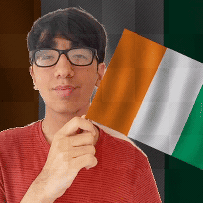 A Man Wearing Glasses Is Holding A Flag In His Hand GIF
