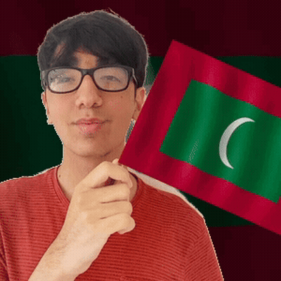 A Man Wearing Glasses Is Holding A Green And Red Flag With A White Crescent Moon On It GIF