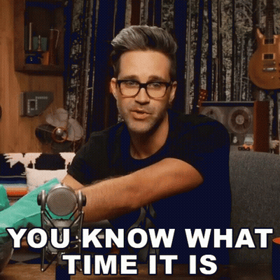 A Man Wearing Glasses Is Holding A Microphone And Says " You Know What Time It Is " GIF