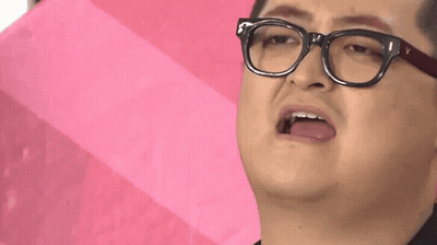 A Man Wearing Glasses Is Holding A Pink Umbrella And Making A Funny Face . GIF