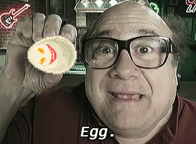 A Man Wearing Glasses Is Holding Up A Pixelated Egg With A Smiley Face On It And The Words Egg Below Him GIF