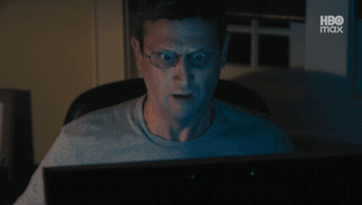 A Man Wearing Glasses Is Looking At A Computer Screen With Hbo Max Written On The Bottom GIF