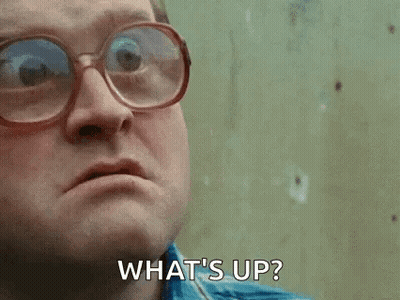 A Man Wearing Glasses Is Making A Face And Saying `` What 'S Up '' . GIF