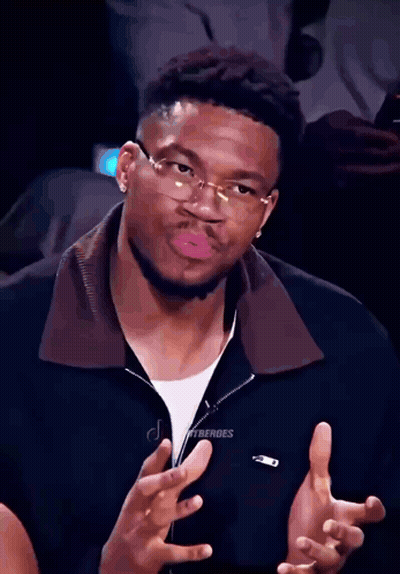 A Man Wearing Glasses Is Making A Funny Face GIF