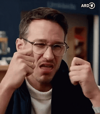 A Man Wearing Glasses Is Making A Funny Face And Making A Funny Face . GIF