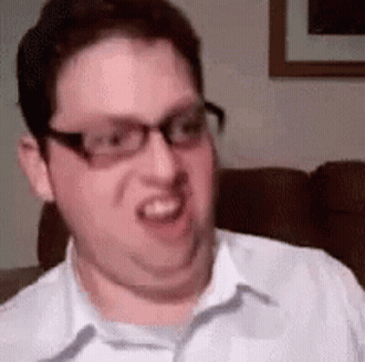 A Man Wearing Glasses Is Making A Funny Face . GIF