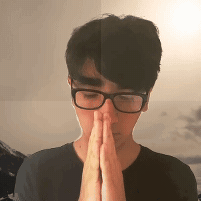 A Man Wearing Glasses Is Praying With His Hands Folded GIF