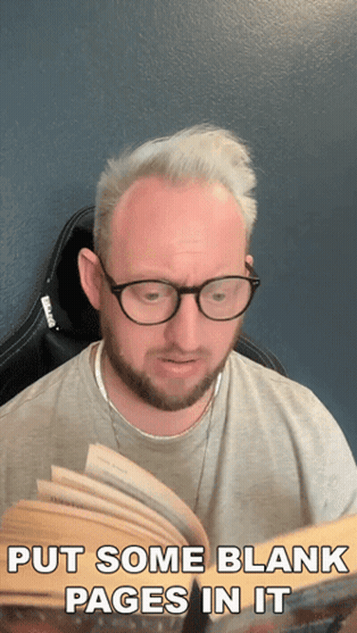 A Man Wearing Glasses Is Reading A Book With The Words Put Some Blank Pages In It GIF