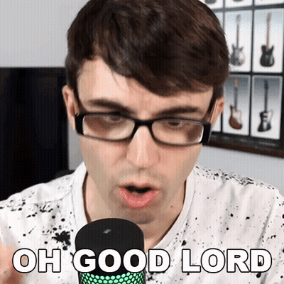 A Man Wearing Glasses Is Singing Into A Microphone With The Words Oh Good Lord Below Him GIF