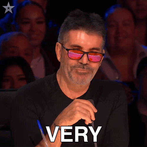 A Man Wearing Glasses Is Sitting In Front Of A Crowd And The Word Impressive Is On The Bottom GIF
