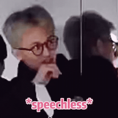A Man Wearing Glasses Is Sitting In Front Of A Mirror With The Word Speechless Written On The Bottom GIF